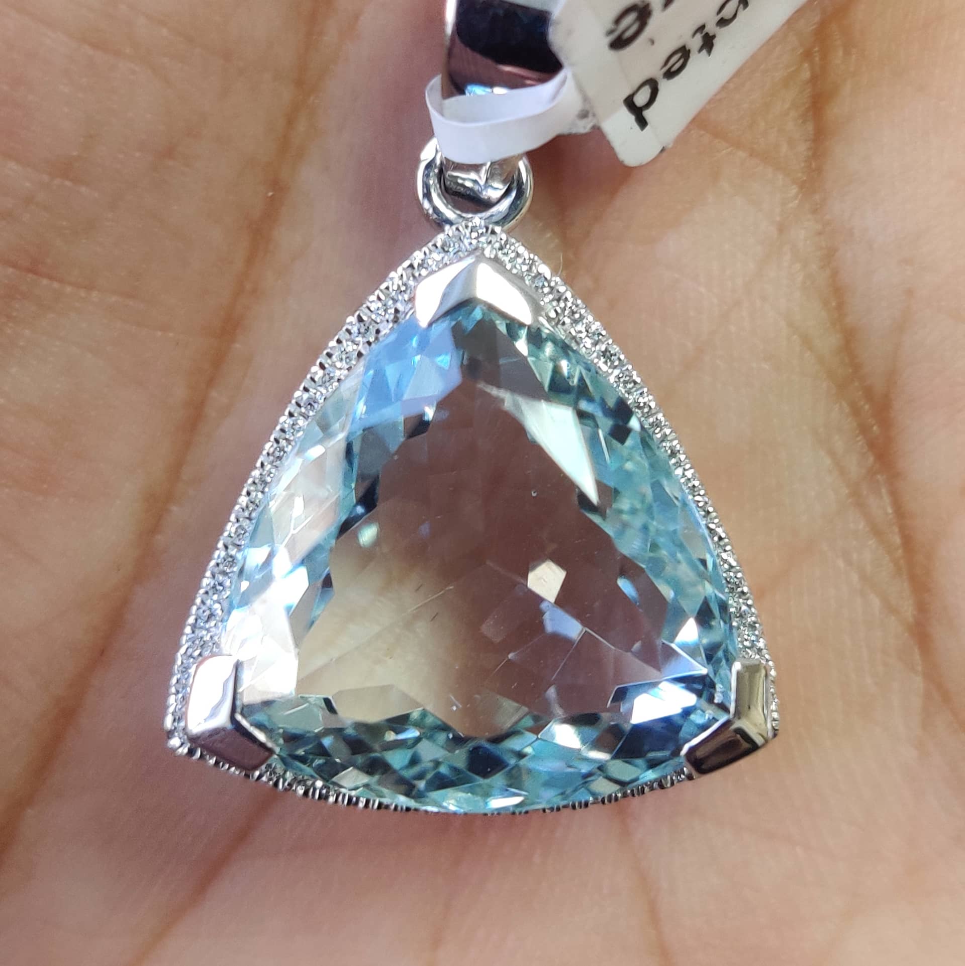 1.50ct triangle shape aquamarine and round diamond Halo set pendant in 18k white gold