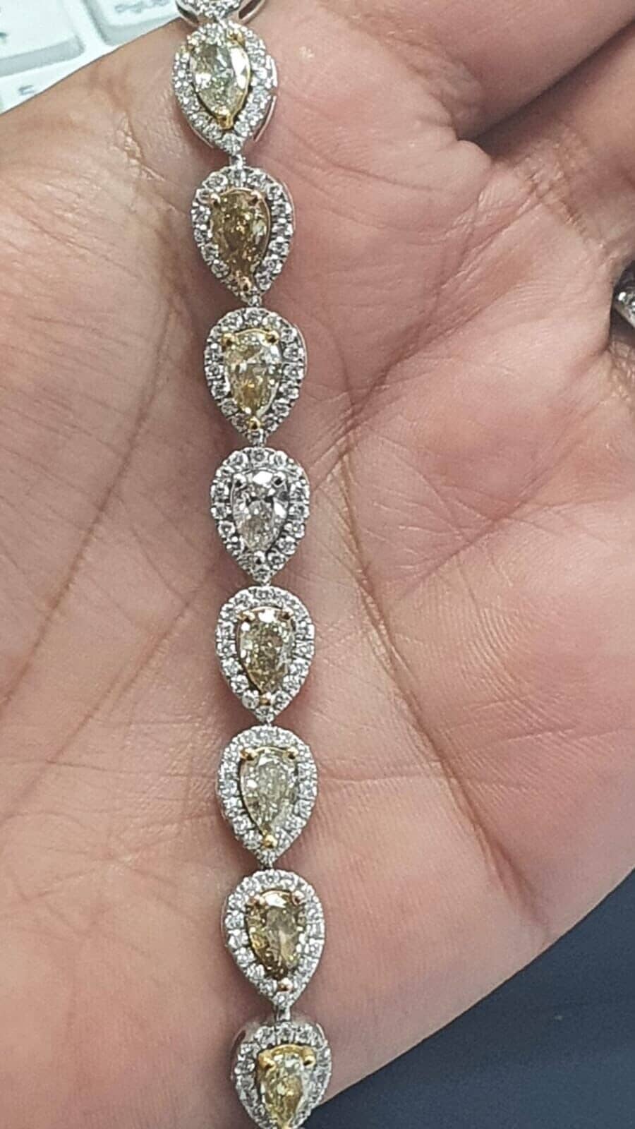 NATURAL FANCY YELLOW PEAR & ROUND DIAMOND HALO TENNIS BRACELET IN 18K WHITE GOLD - 13.50 CT