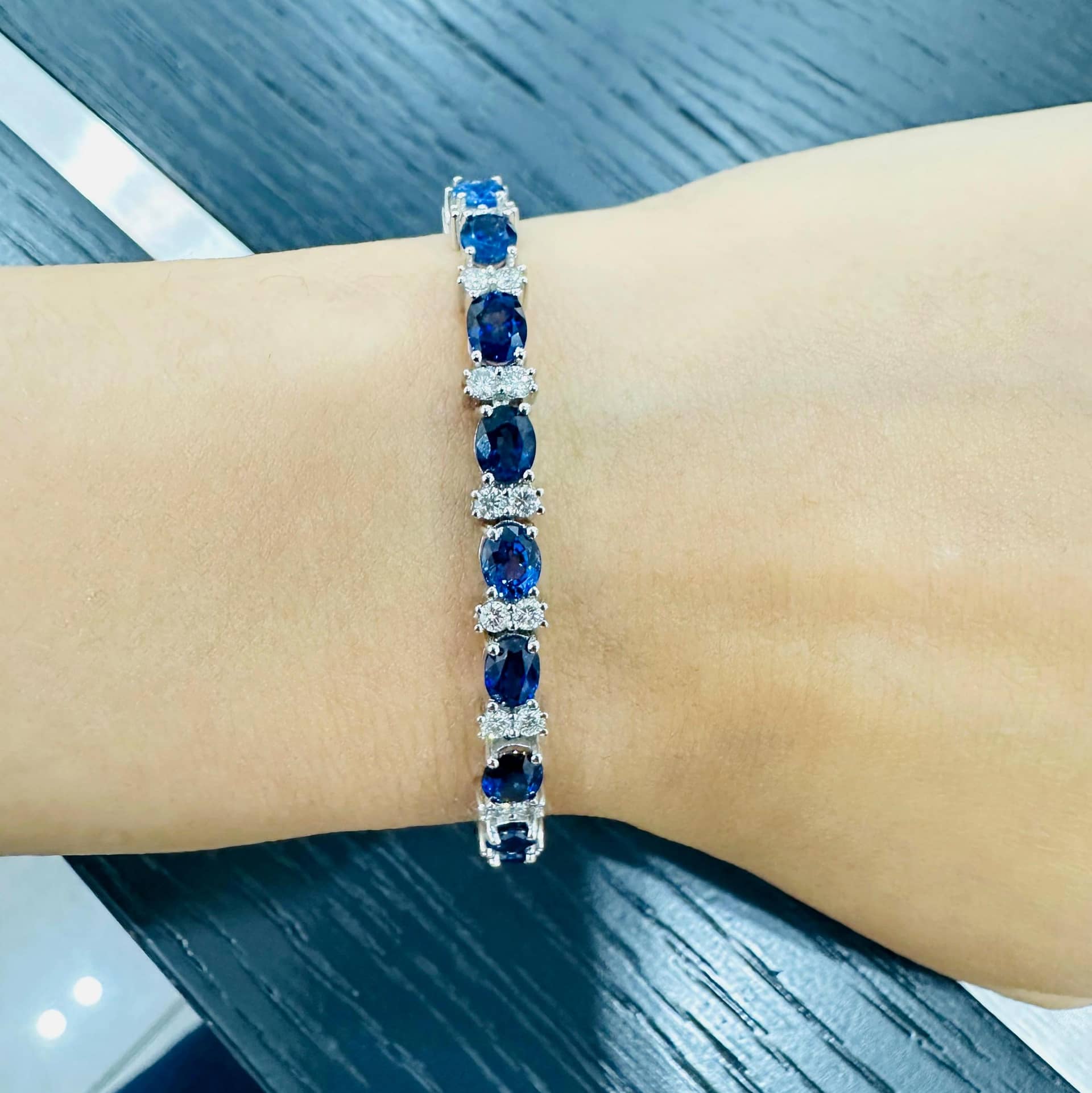 12.60 CARAT SAPPHIRE OVAL AND DIAMOND HALO TENNIS BRACELET IN 18K WHITE GOLD