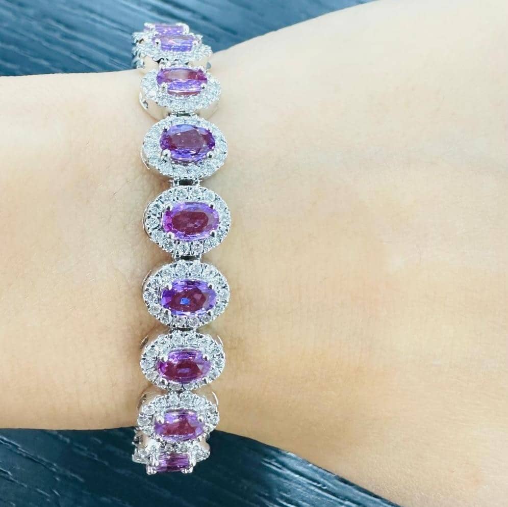 15.00 CARAT PINK OVAL SAPPHIRE AND DIAMOND HALO BRACELET IN 18K WHITE GOLD