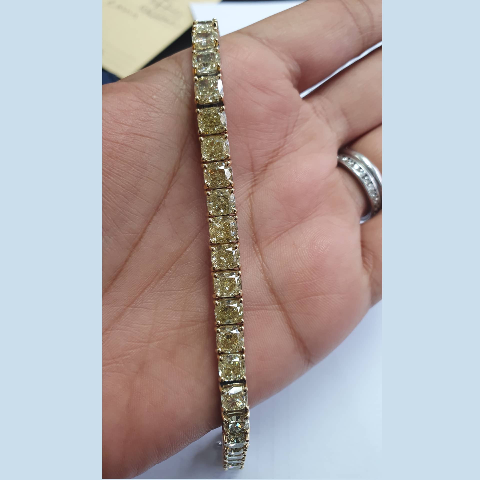WGI CERTIFIED 28.54 CARAT FANCY INTENSE YELLOW CUSHION DIAMOND TENNIS BRACELET IN 18K GOLD