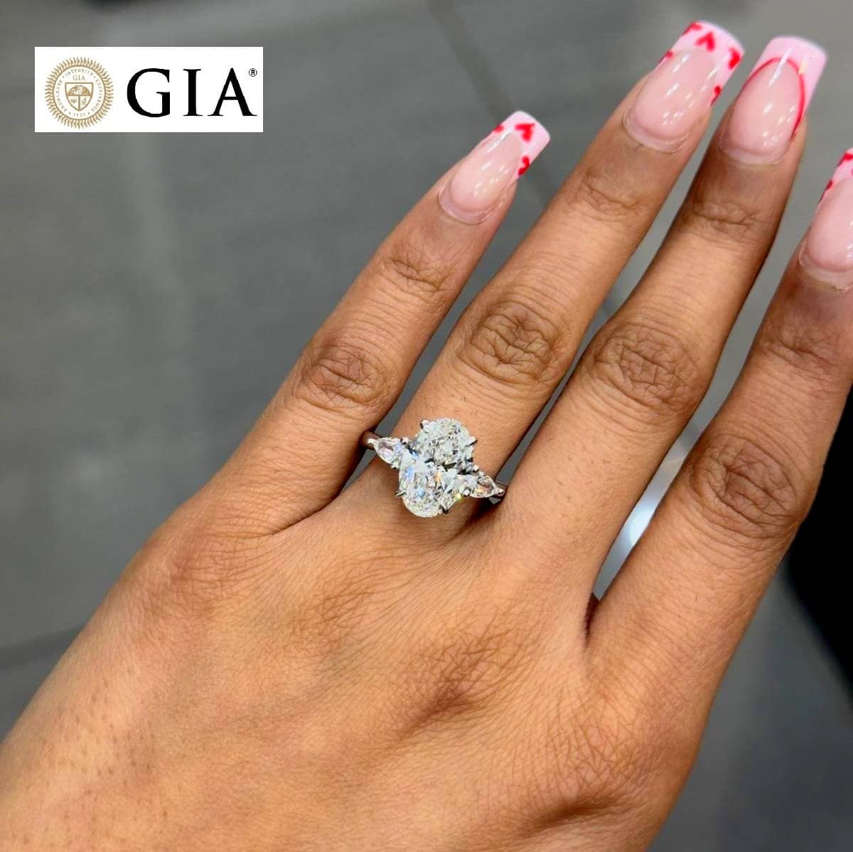 GIA CERTIFIED 2.00CT OVAL WITH SIDE PEAR DIAMOND TRILOGY RING IN PLATINUM